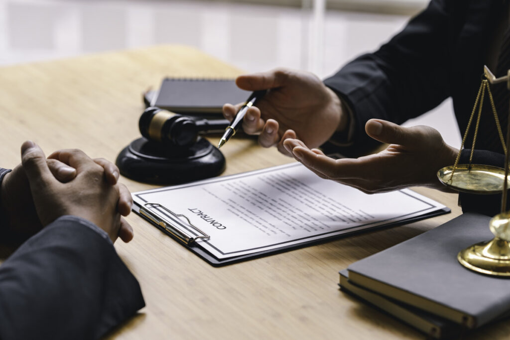 Two individuals in a formal setting discussing a contract document, illustrating what is the statute of limitation on medical malpractice. The image highlights the importance of legal advice and documentation in medical malpractice cases.