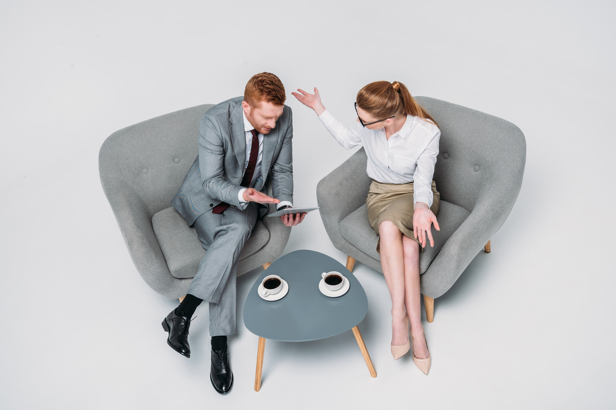 Two individuals seated in modern armchairs during a discussion, illustrating what is the difference between legal separation and divorce. The setting highlights the importance of understanding marital legal options
