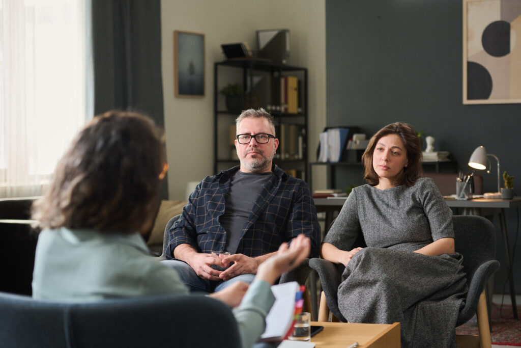 Two individuals seated in modern armchairs during a discussion, illustrating what is the difference between legal separation and divorce. The setting highlights the importance of understanding marital legal options