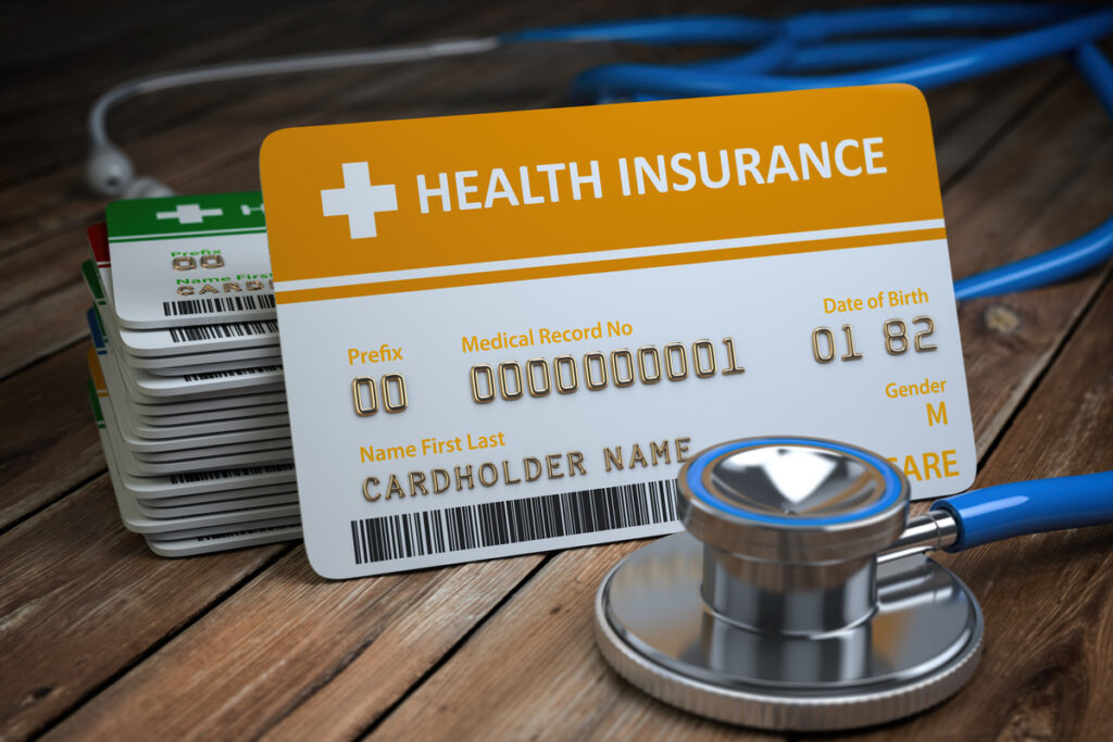 Health insurance card on a wooden surface with a stethoscope in the background, illustrating what is the difference between legal separation and divorce. This image emphasizes the importance of understanding marital legal options.