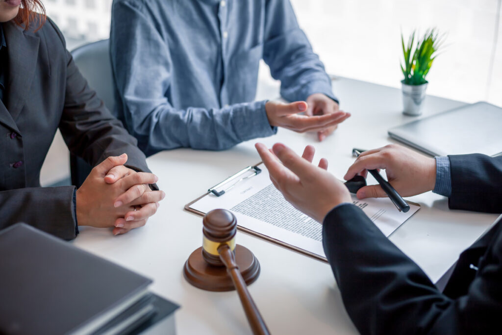A man and woman at a table with a gavel, discussing their collaborative divorce process