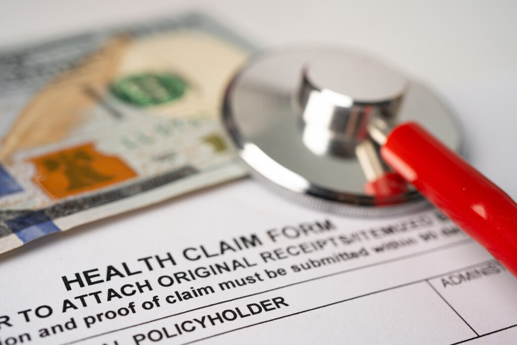 Health insurance claim form alongside a stethoscope, symbolizing medical care after a slip and fall accident