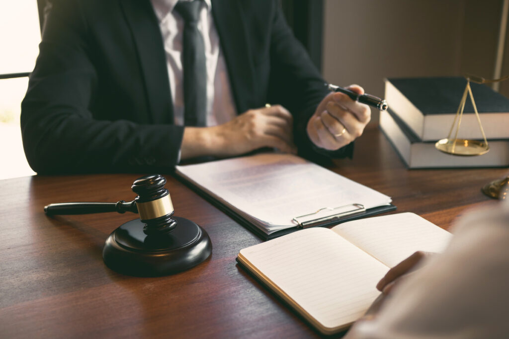 A lawyer advises a client in an office setting about steps to take after a slip and fall accident