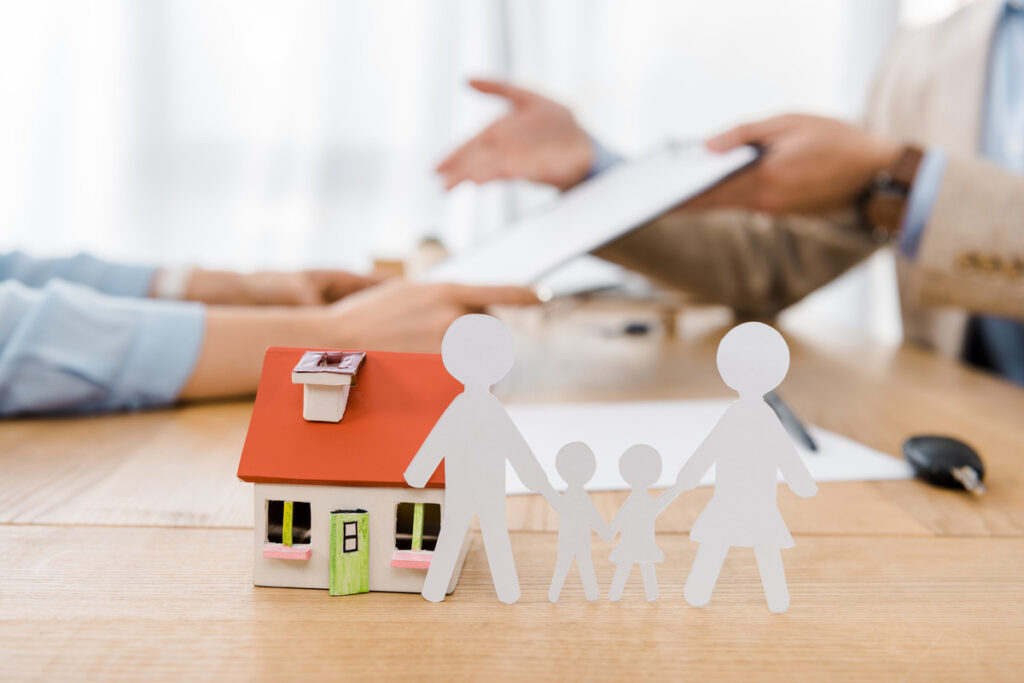 A family home interior featuring a table with a paper cutout of a family, symbolizing unity amidst legal challenges
