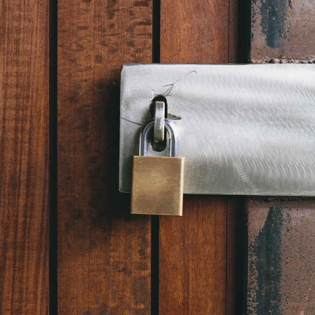 A padlock secured on a wooden door, symbolizing protection and legal boundaries in property division matters