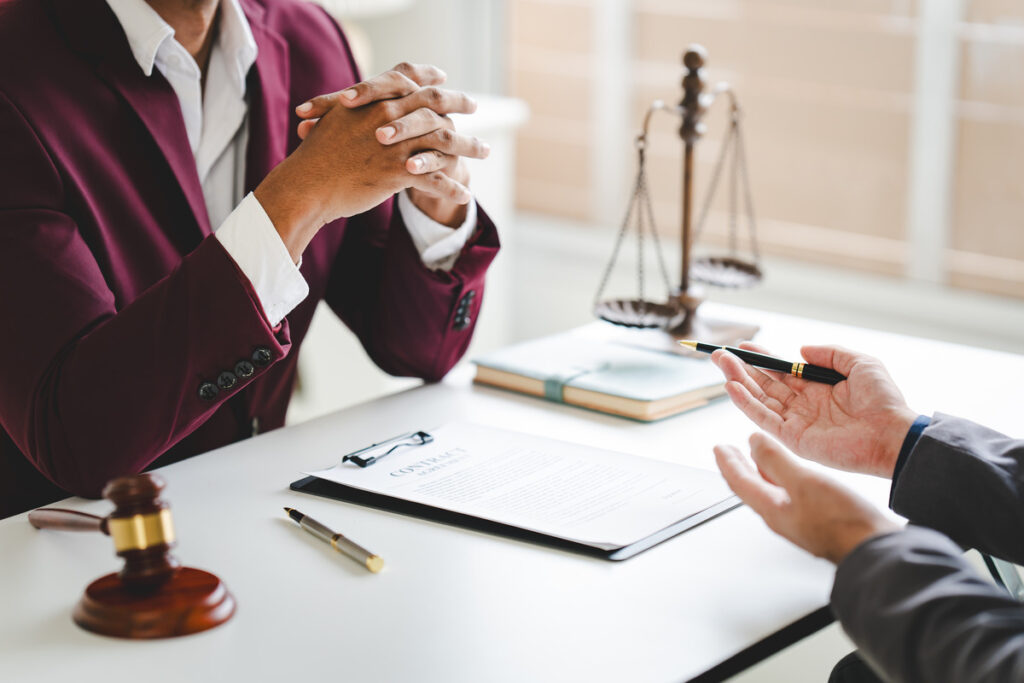 A laywer converses with the client, both engaged in a professional discussion