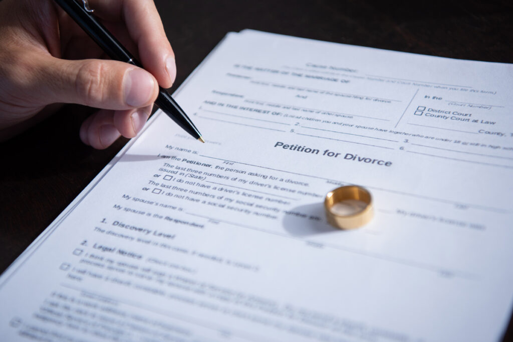 A wedding ring rests on a marriage certificate, symbolizing commitment and legal union, relevant to family law in Houston