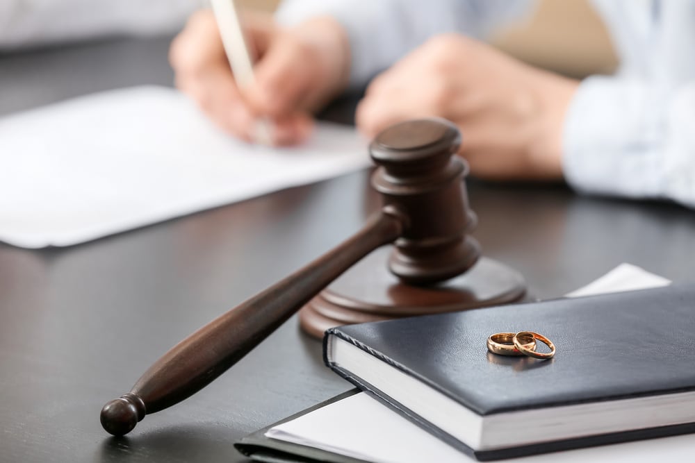Wedding rings placed on a judge's desk, symbolizing the divorce process in Texas