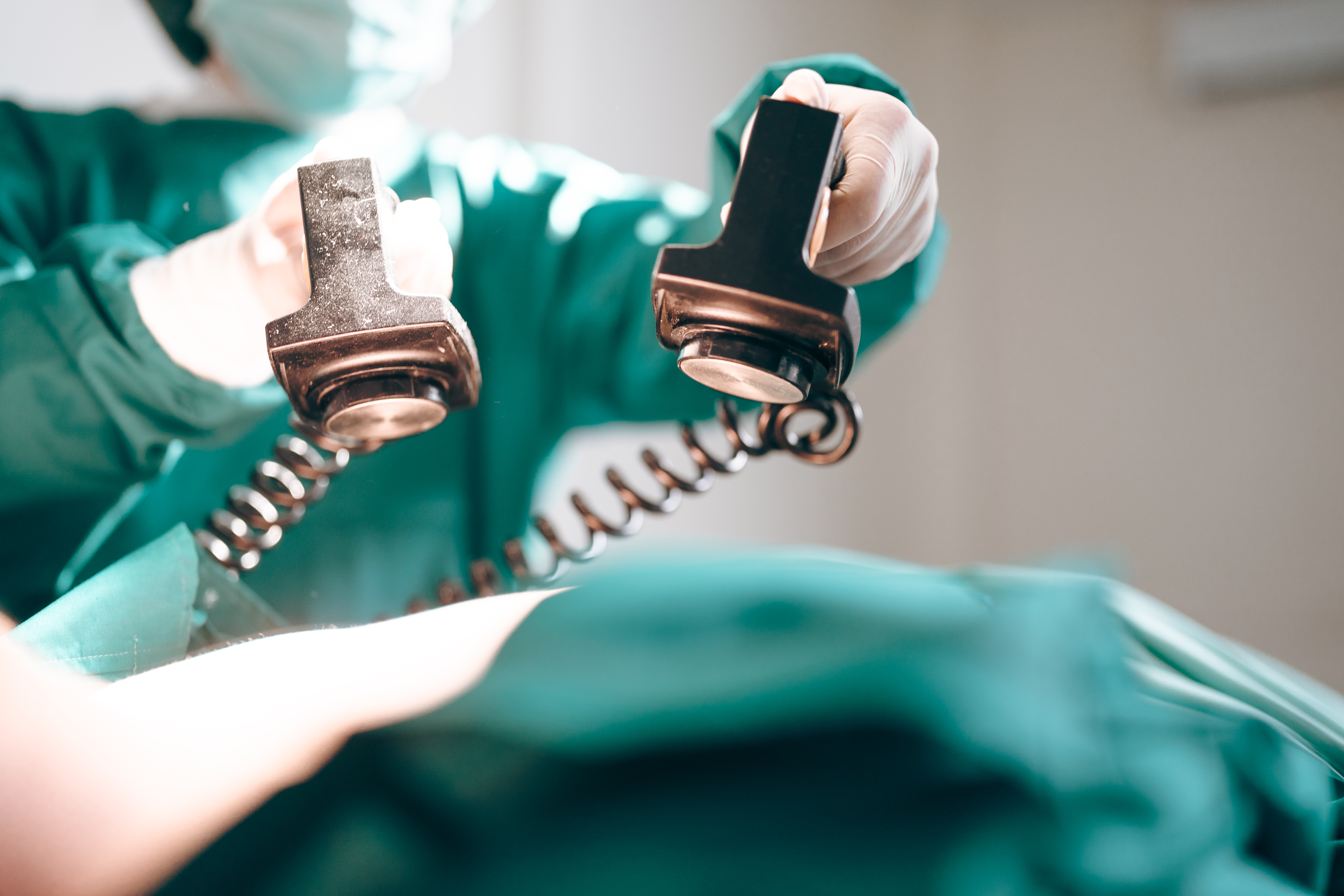 A surgeon skillfully holds a pair of scissors, symbolizing precision in surgical procedures and the importance of patient safety