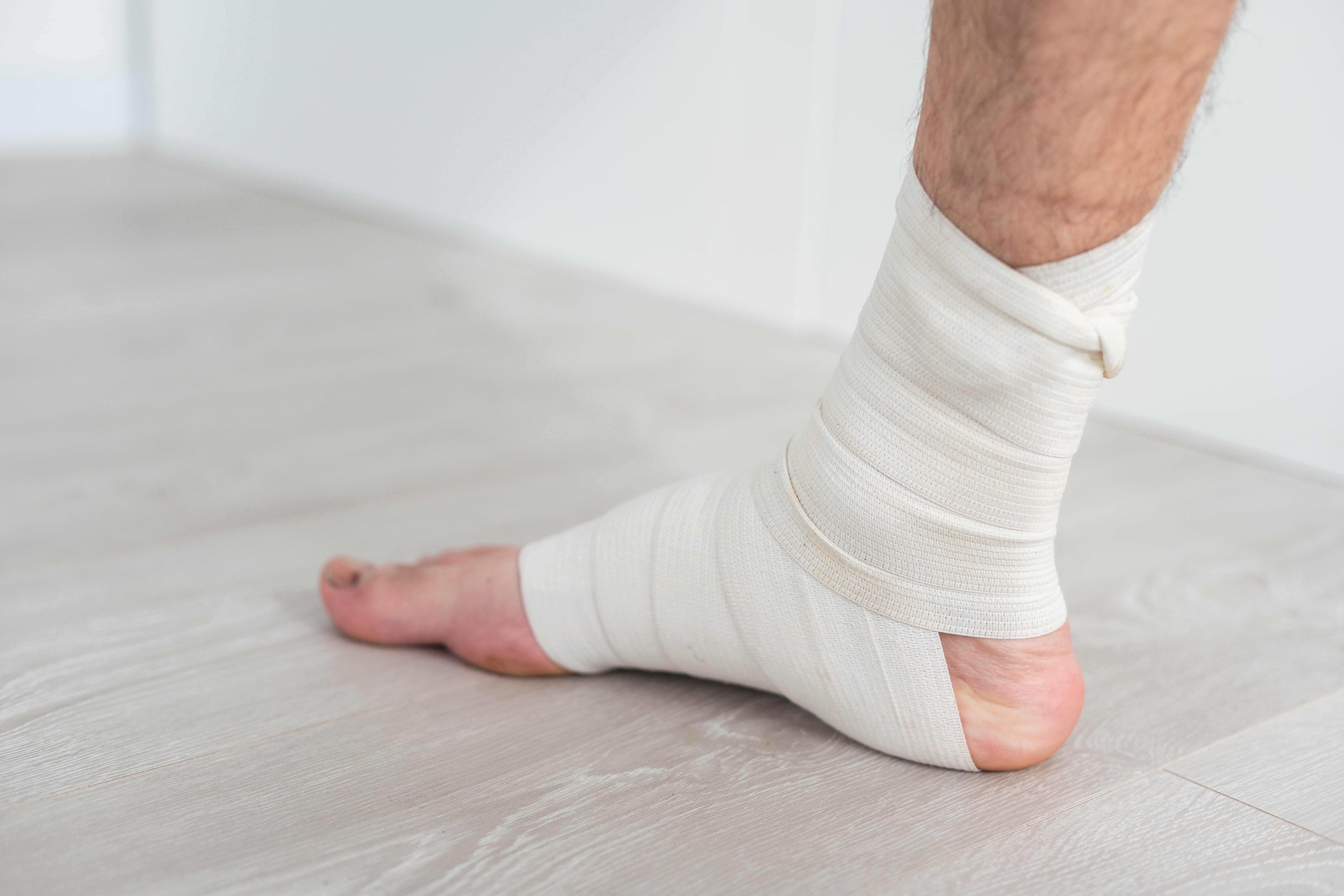 A man with a bandage on his foot, illustrating a potential case of medical malpractice or negligence in healthcare
