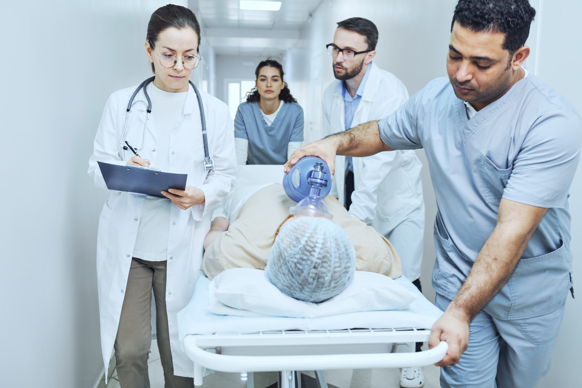 A group of healthcare professionals attending to a patient, highlighting teamwork in medical care and patient support