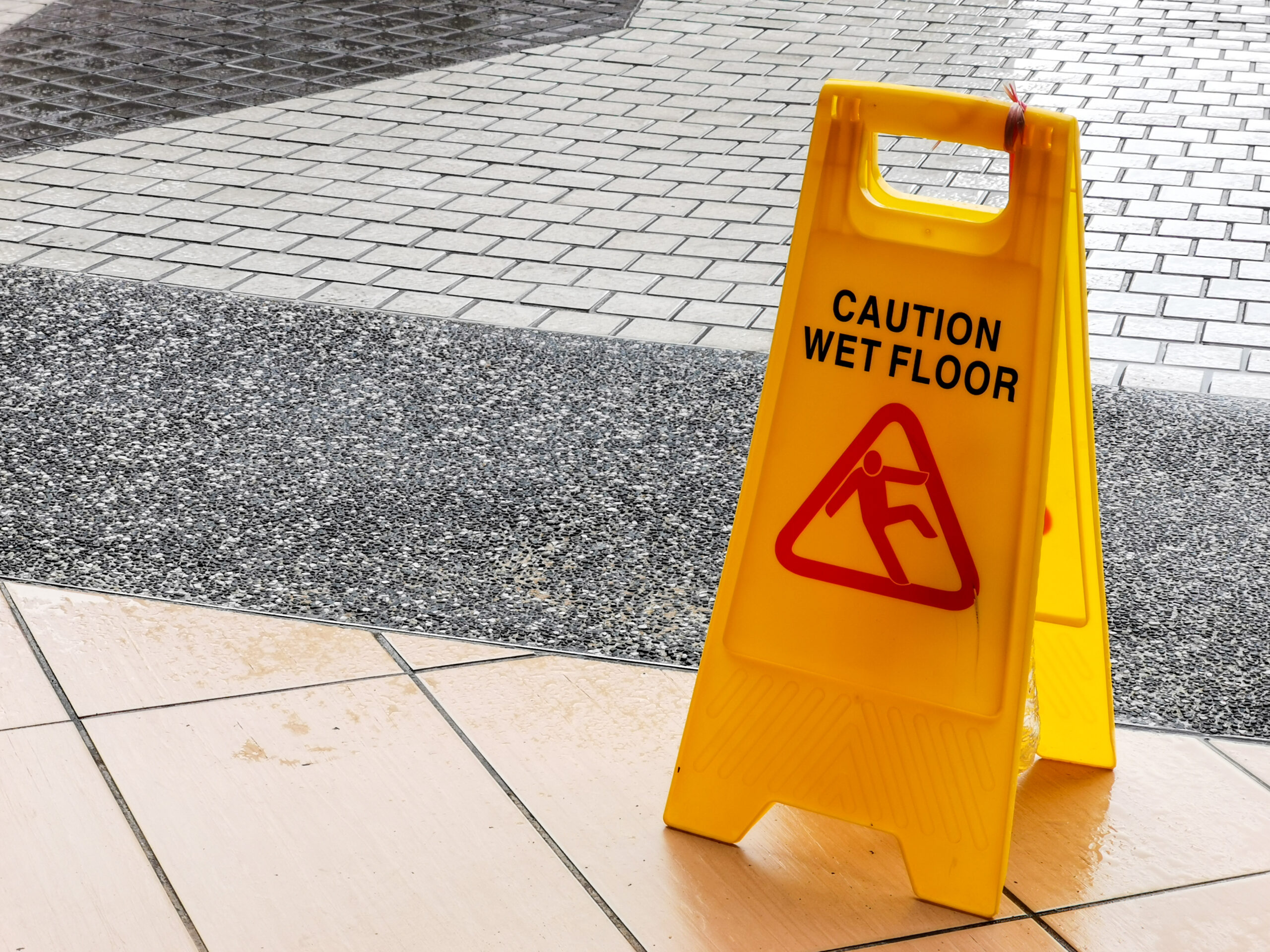 A caution floor sign placed on the ground, alerting individuals to potential hazards in the area