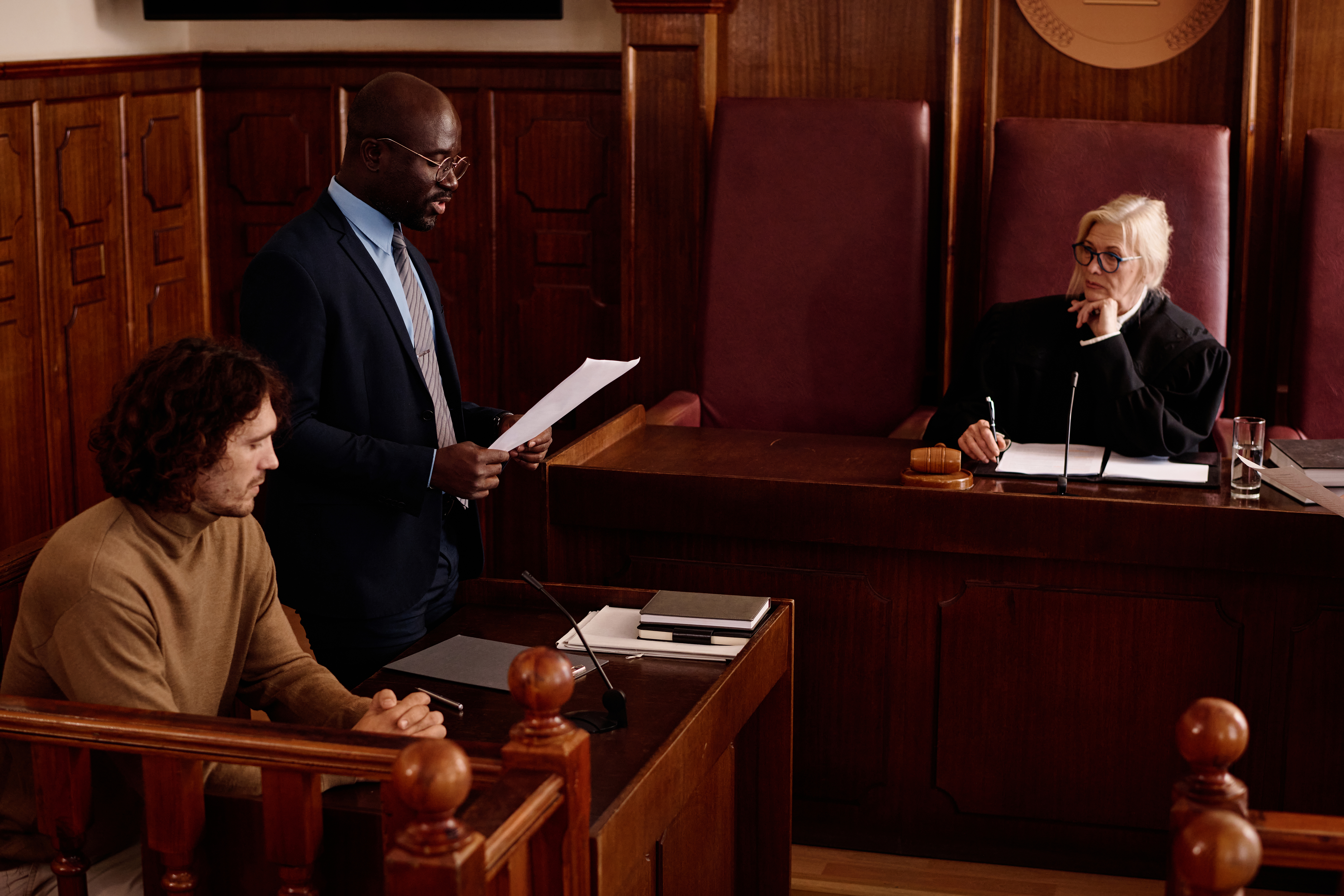 A man addresses a courtroom audience regarding the process of filing a child support complaint