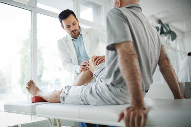 A doctor helping a patient on his therapy
