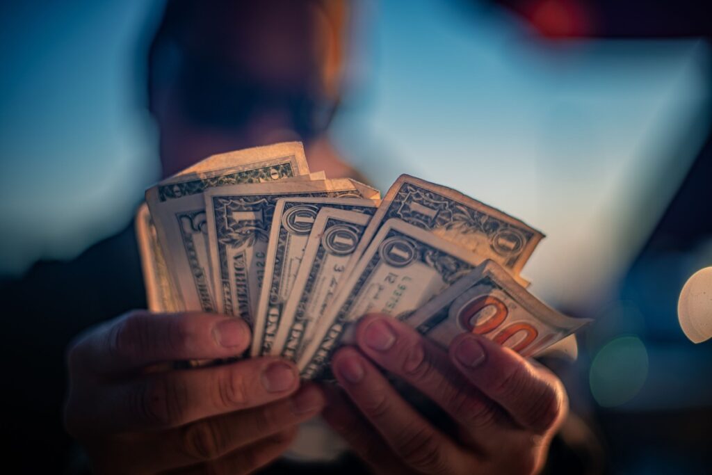 A man counting bills for the child support payment