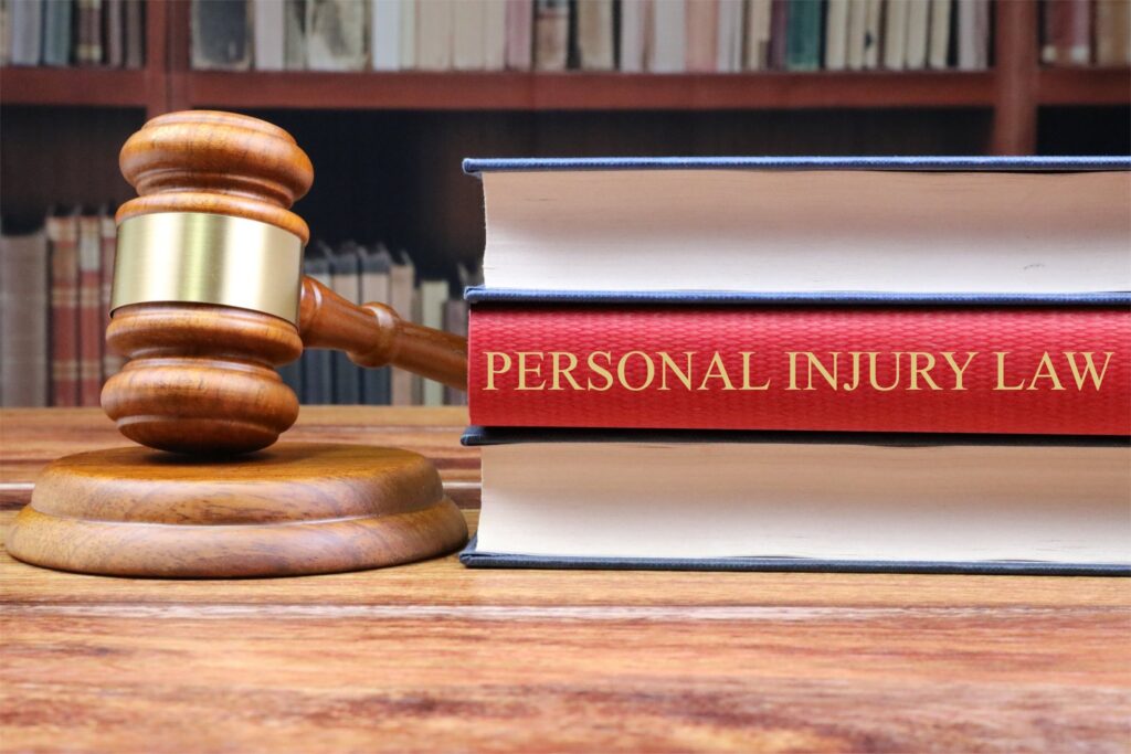 A gavel with a personal injury law book on the table
