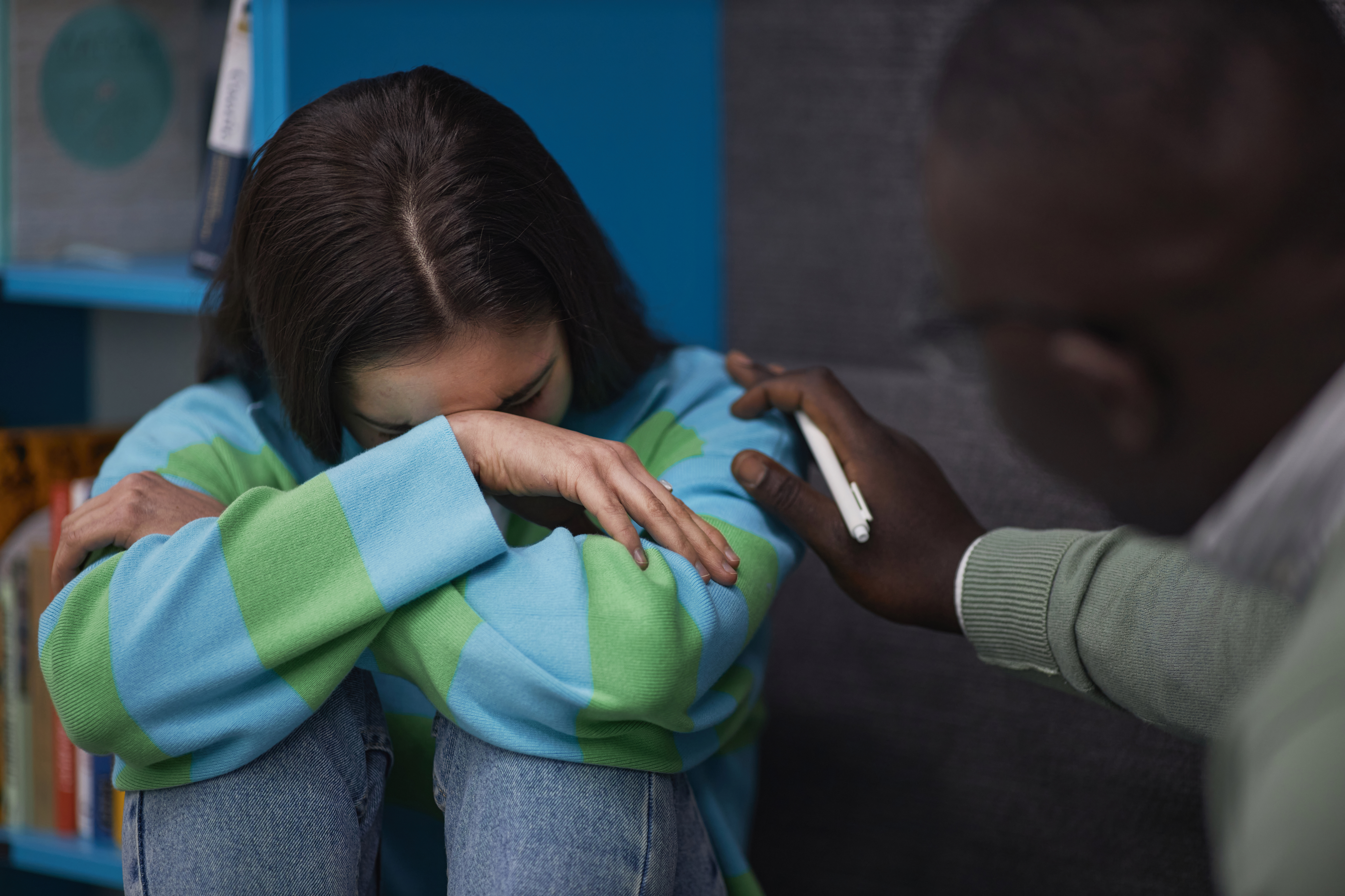 A woman crying while on a therapy session