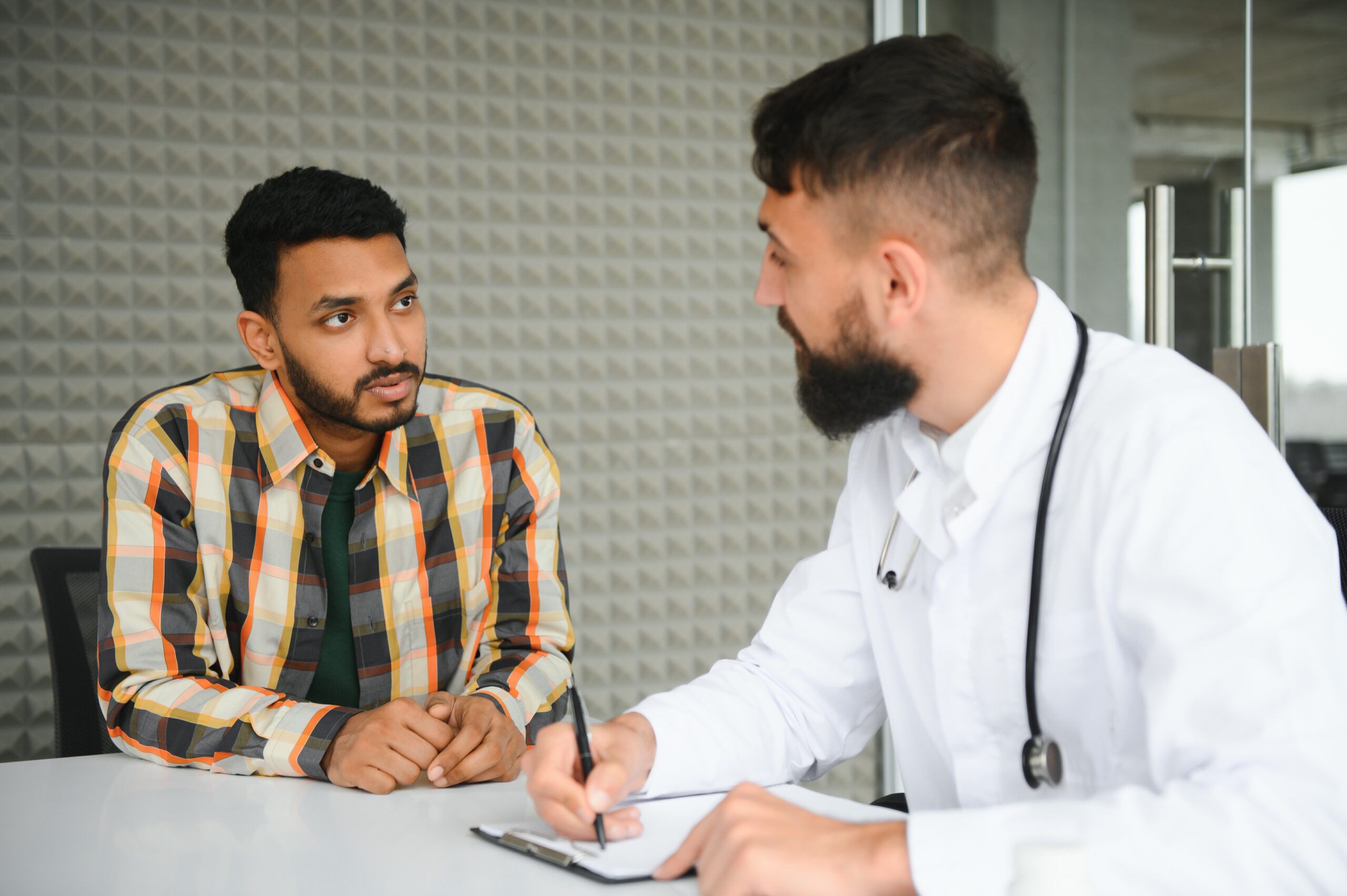 a man consulting a specialist about the emotional distress