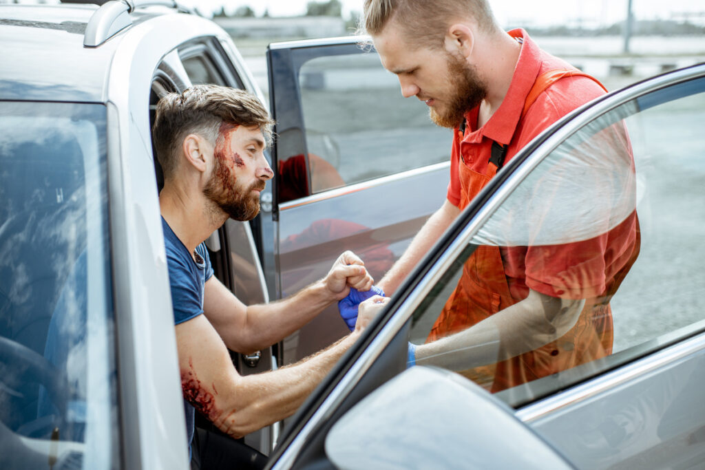 A paramedic assisting an injured driver